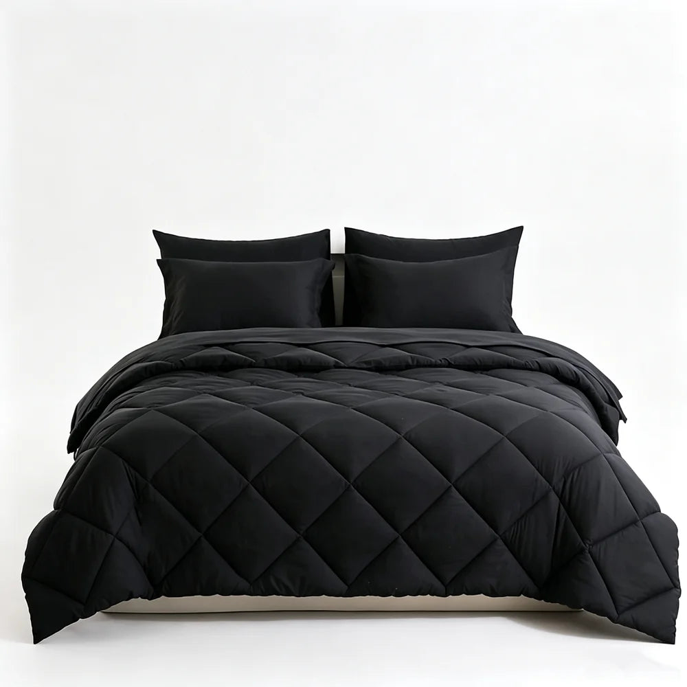 Black quilted bedding set with matching pillowcases on a bed
