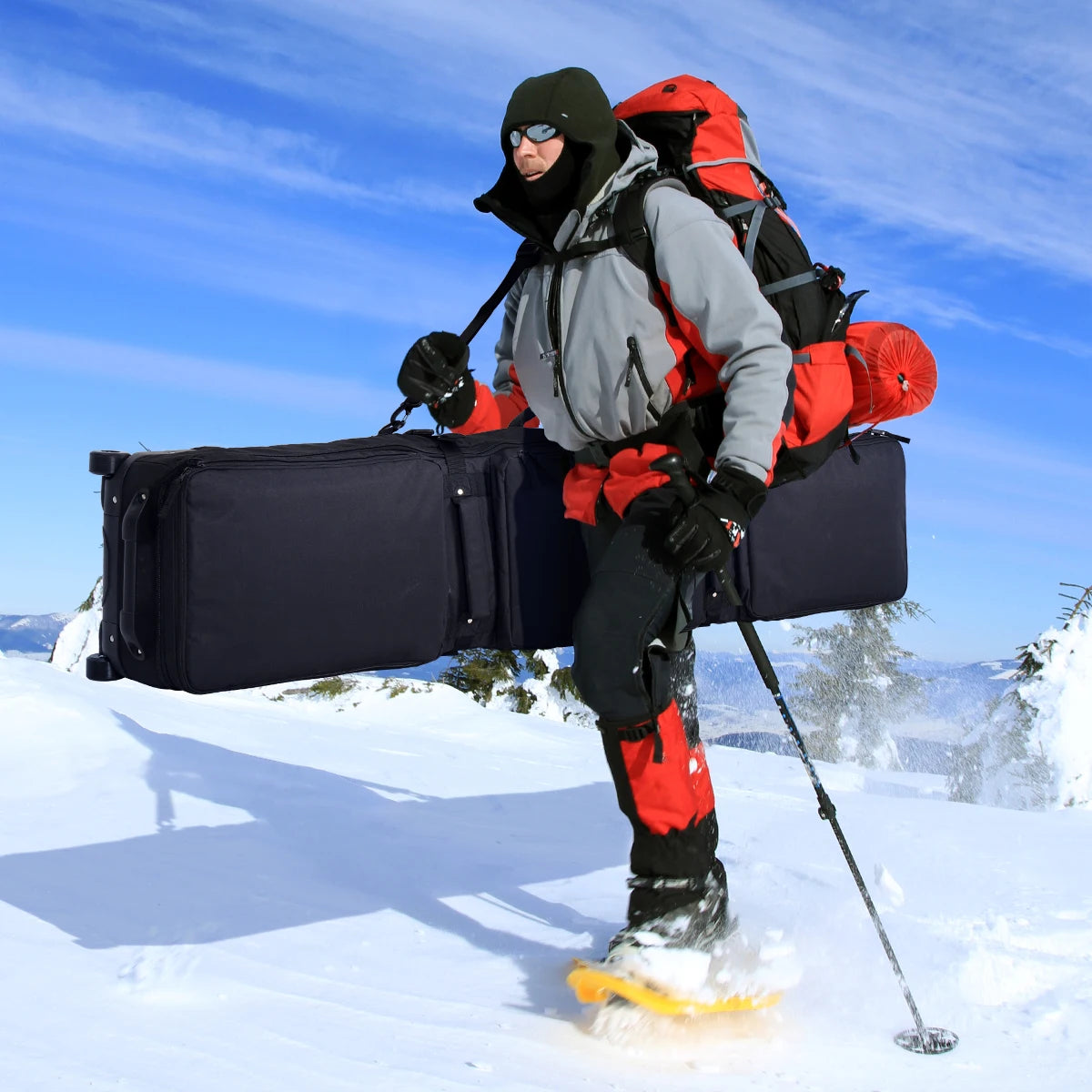 600D fully padded snowboard bag, black waterproof wheel travel bag carried by a climber in snowy mountains.