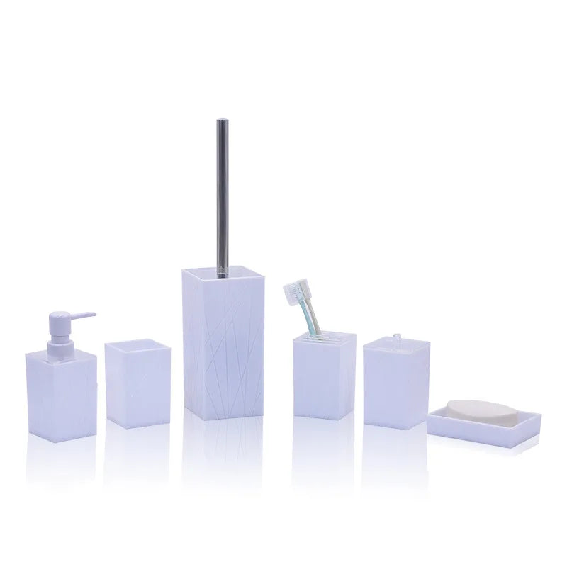 White six-piece bathroom set including soap dispenser, toothbrush holder, cup, tall toilet brush holder, small storage jar, and soap dish