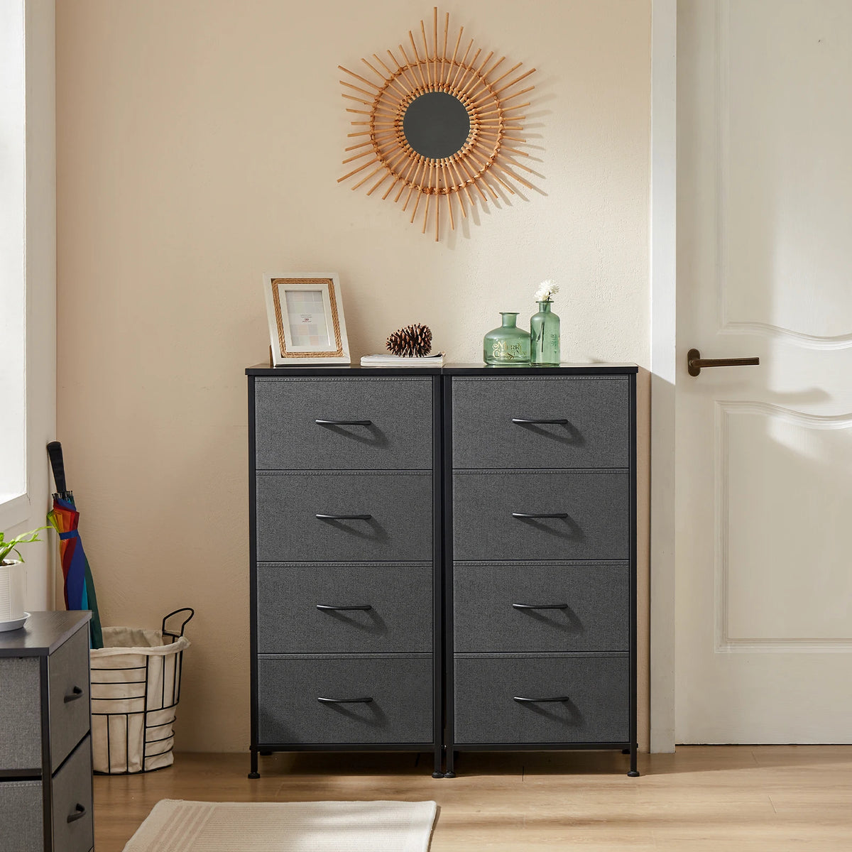 Pair of JHK dressers with four dark gray fabric drawers and steel frames in a bedroom with decor on top