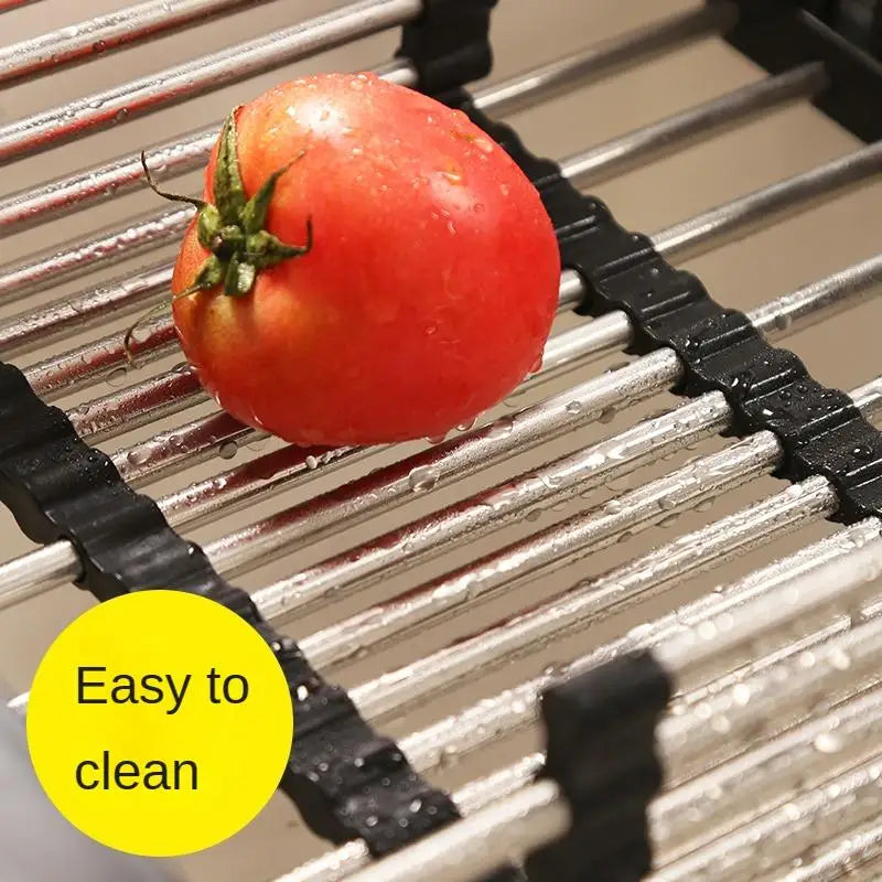 Adjustable stainless steel dish drying rack over sink with black plastic joints; tomato on rack, easy to clean