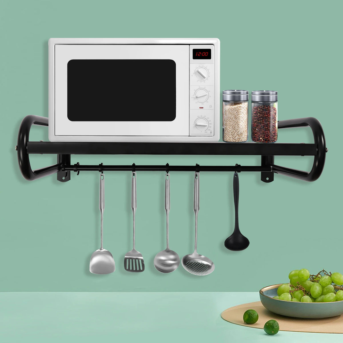 Carbon steel wall-mount microwave shelf in black metal with hanging utensils and spice jars