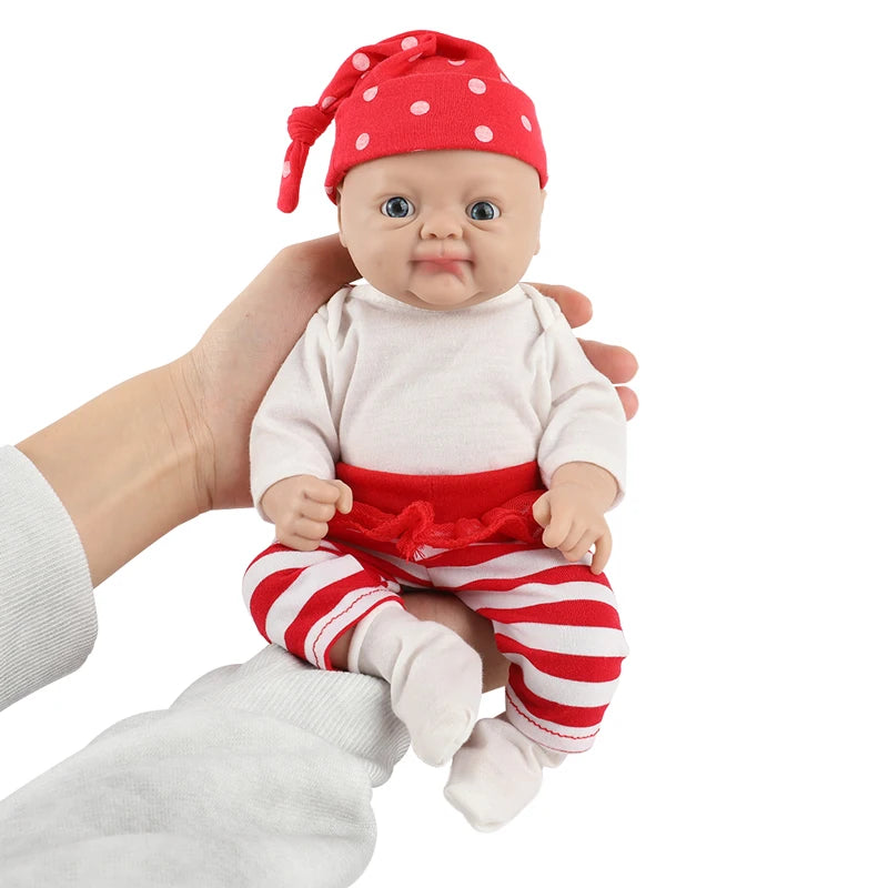 IVITA silicone reborn baby doll by S And B Enterprise; lifelike girl with red polka-dot hat, white top, red-striped pants