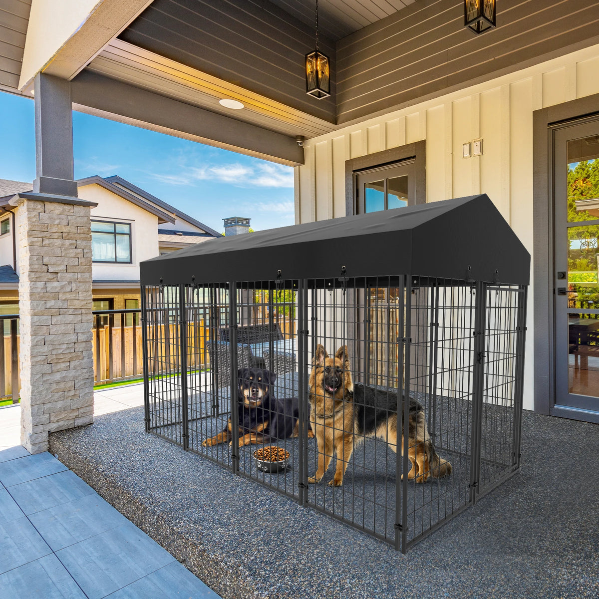 Large outdoor dog kennel with welded wire and a black waterproof canopy; two dogs inside.