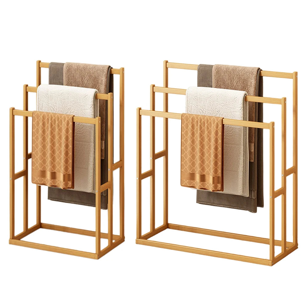 Two wood vertical towel racks with three hanging crossbars and neutral towels.