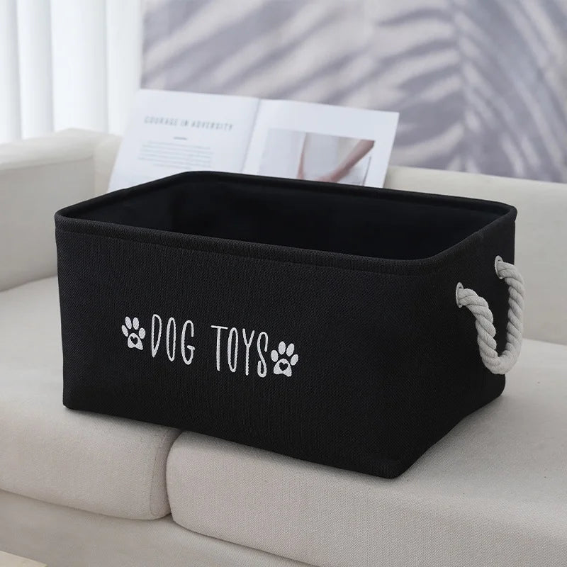Pet toy storage basket, black woven polyester with white rope handles, DOG TOYS label.