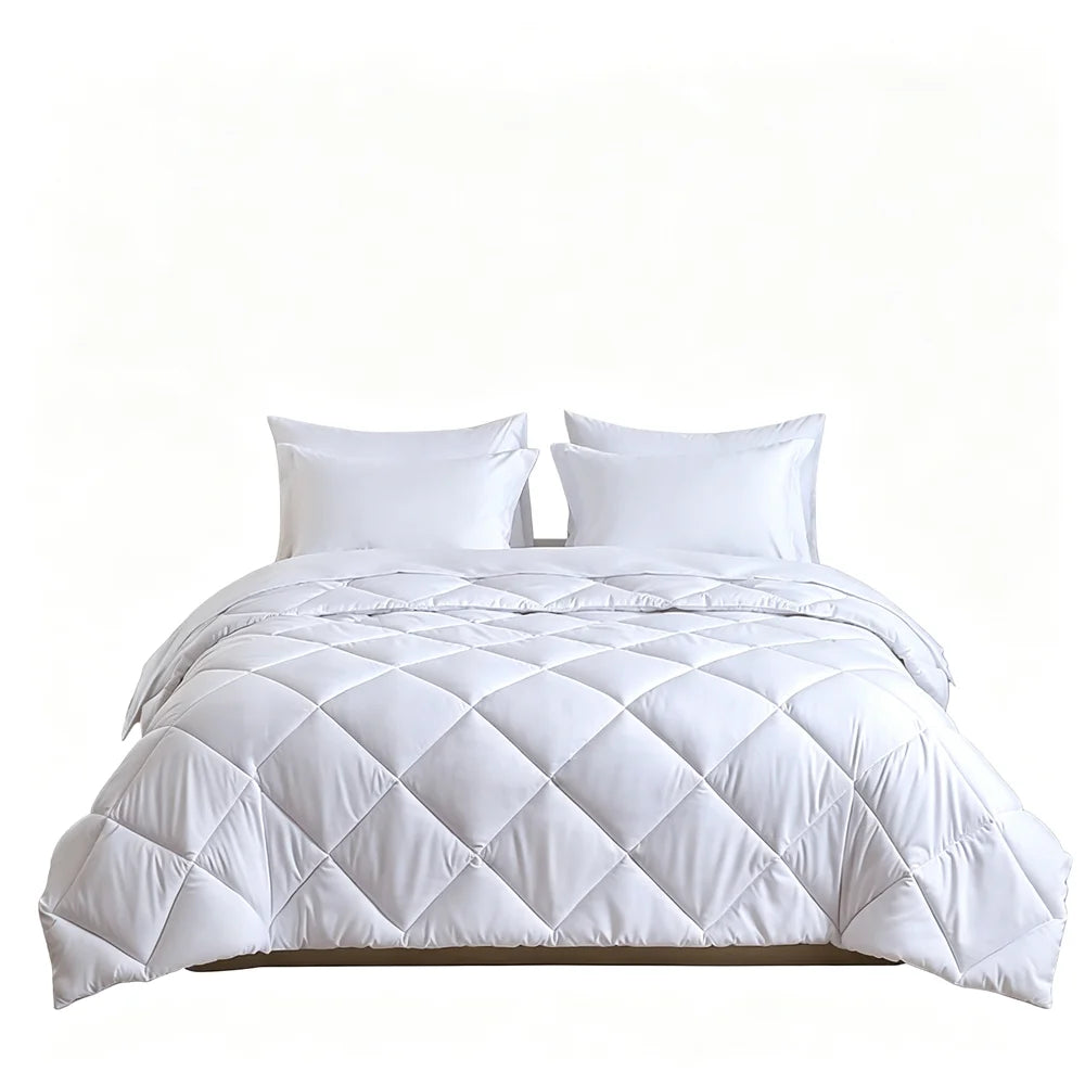 White quilted bedding set with 2 pillows on a bed
