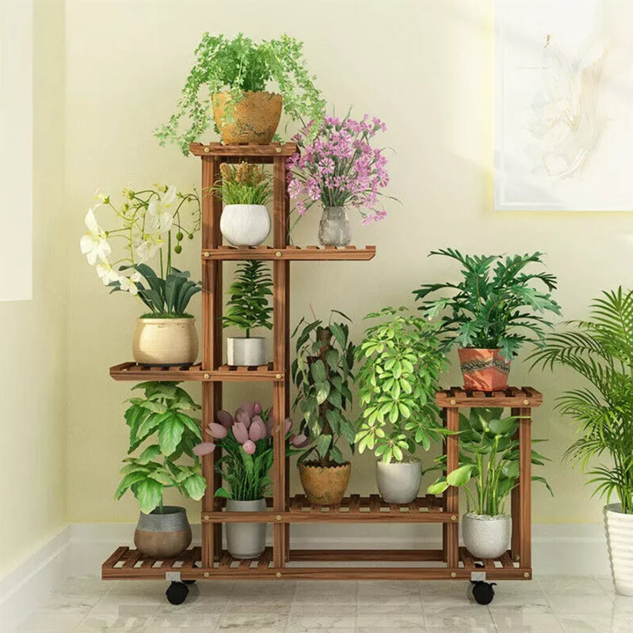 Multi-layer wooden plant stand on wheels by S And B Enterprise with multiple potted plants