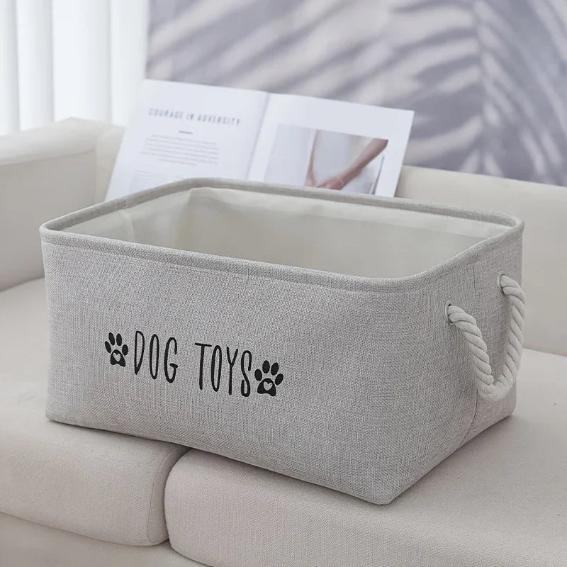 Pet toy storage basket in gray woven polyester with rope handles and DOG TOYS print