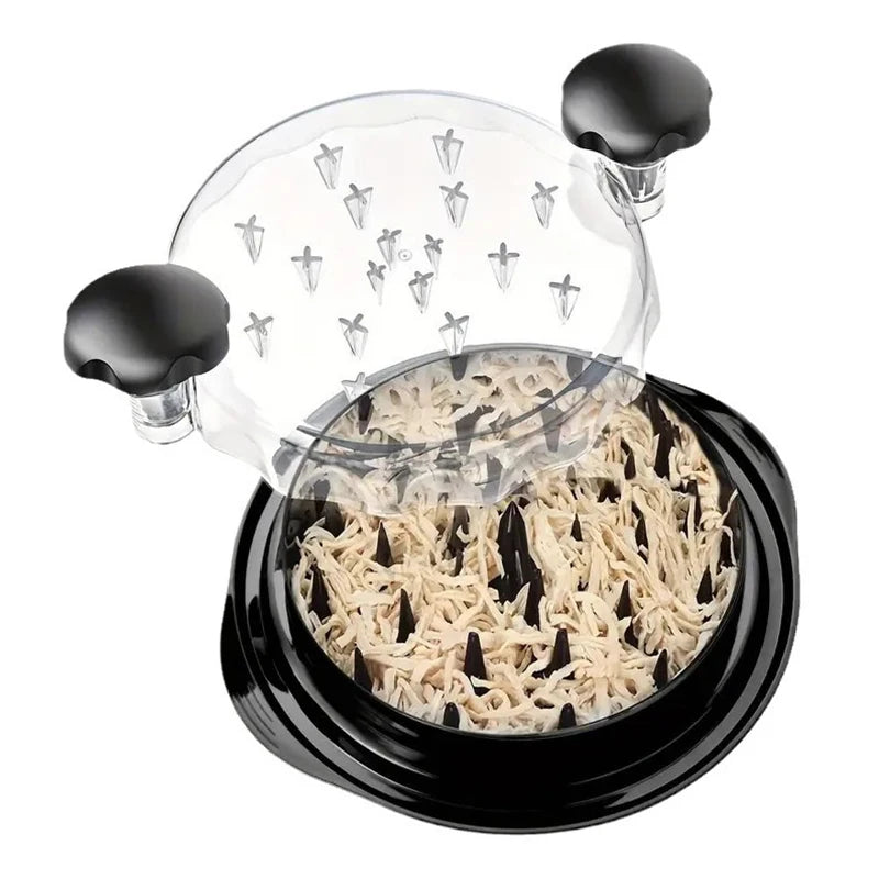 Chicken meat shredder by S And B Enterprise; black base with transparent lid and sharp blades, shredded chicken inside