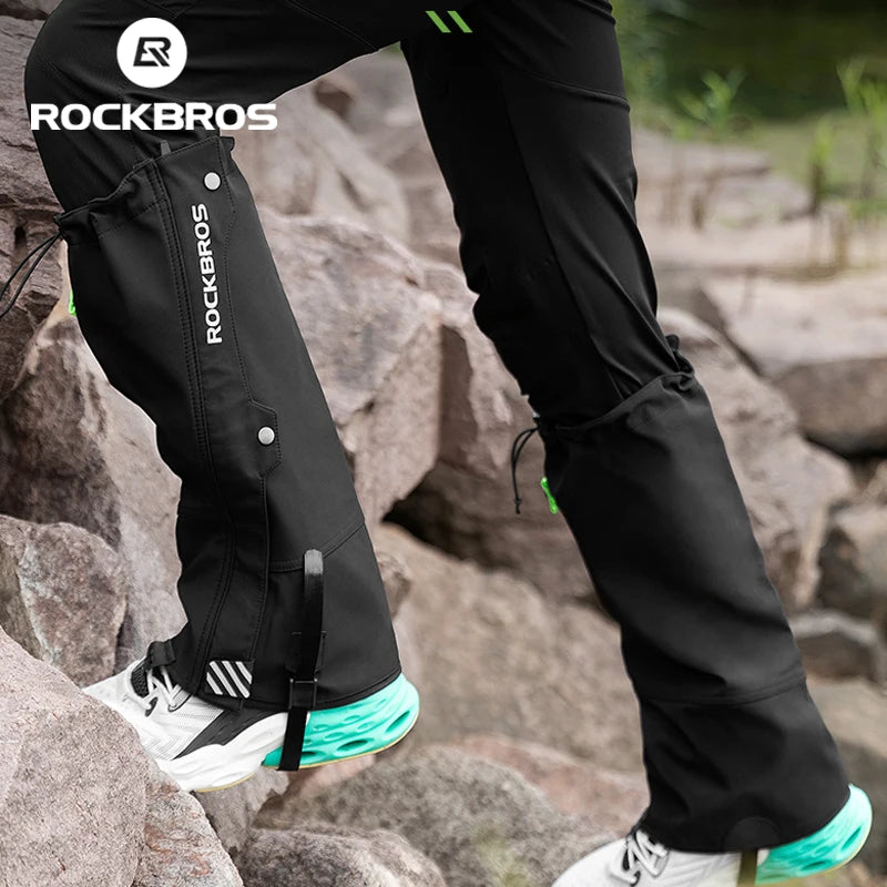 ROCKBROS waterproof leg gaiters for hiking, black with green accents, worn over pants on rocky terrain.