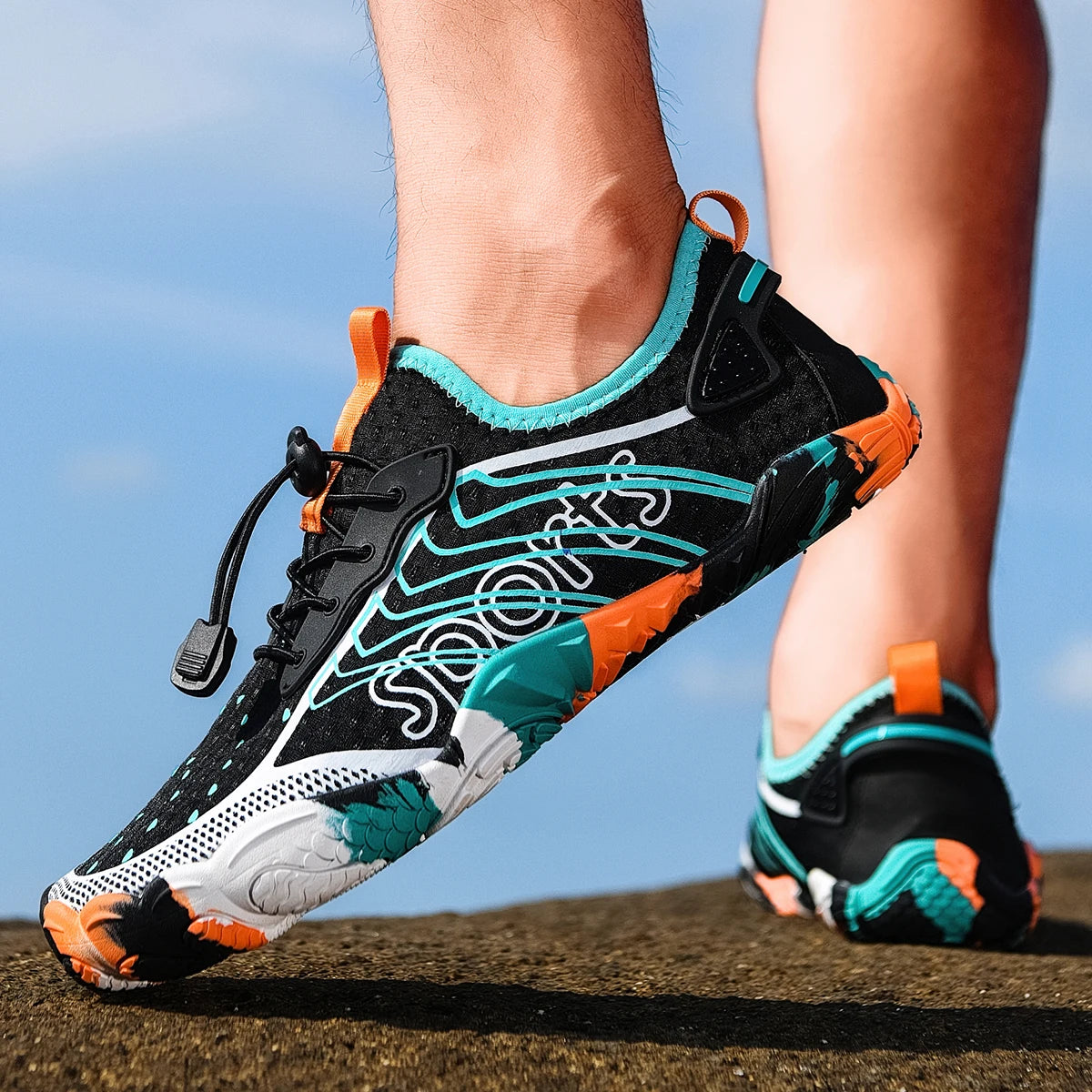 Men's quick-dry water shoes in black with teal trim and orange sole accents.