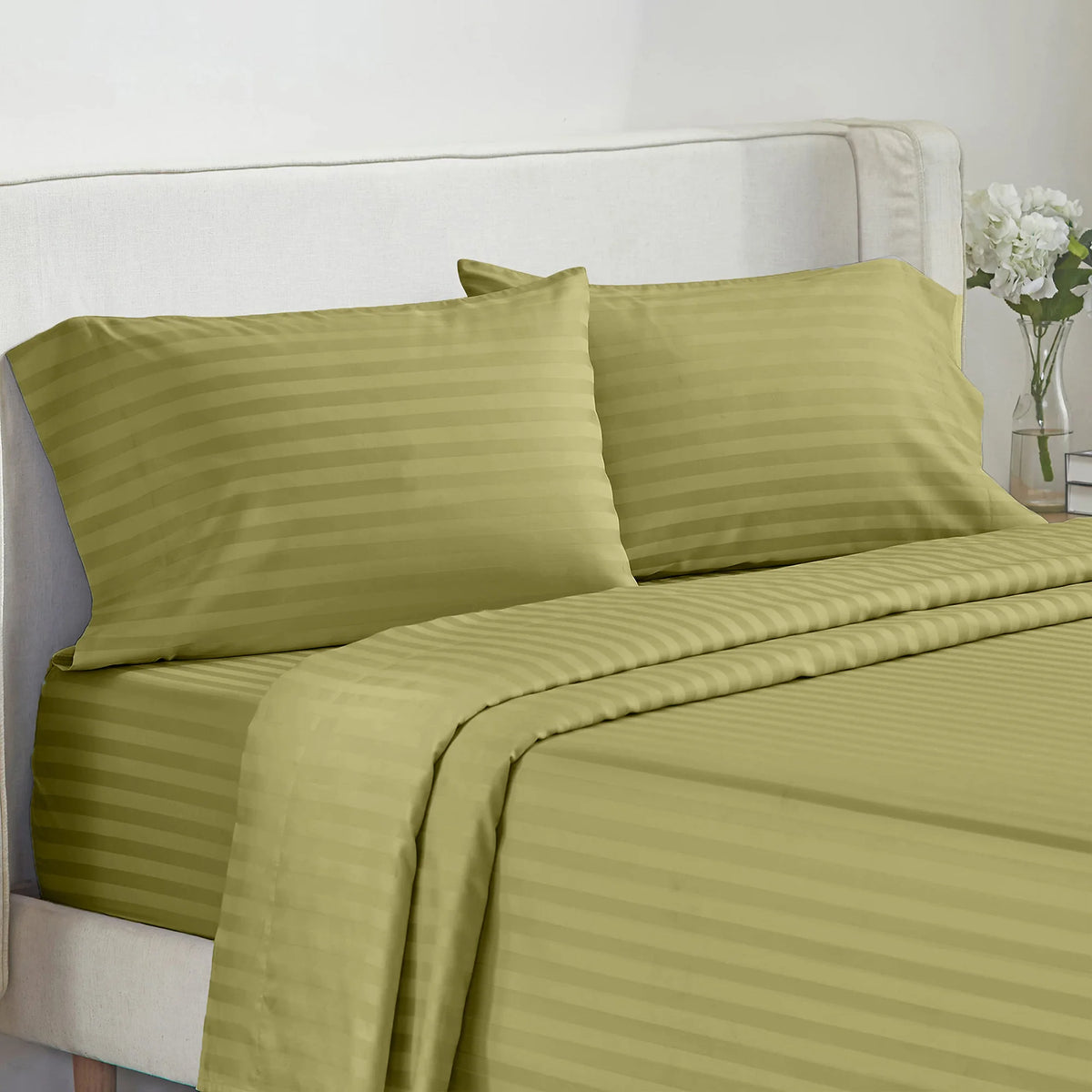 Battilo 4-piece striped olive-green bed sheet set with pillowcases on a white bed