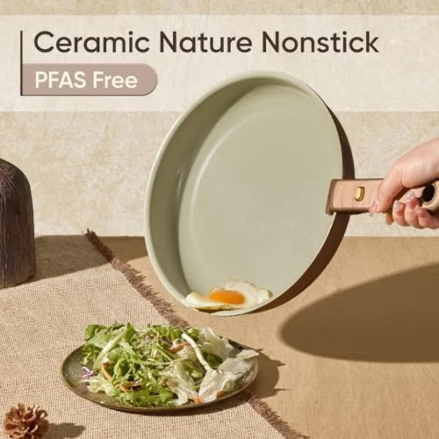 Ceramic nonstick cookware set by S And B Enterprise with detachable handle; light green pan cooking an egg beside a salad plate.