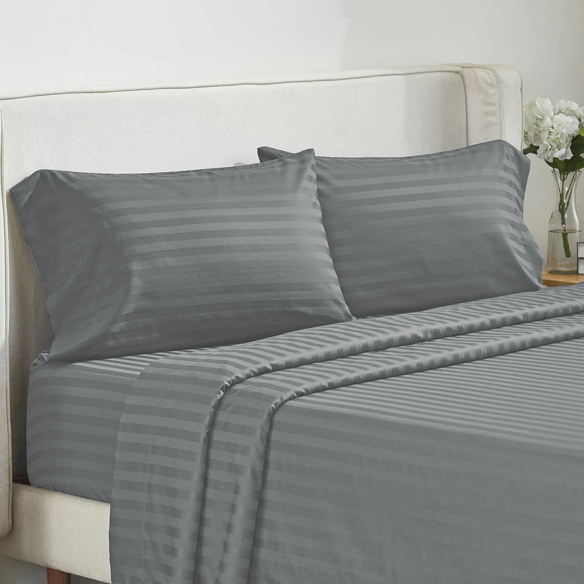 Battilo 4-piece gray striped bed sheet set with pillowcases on a neutral bed