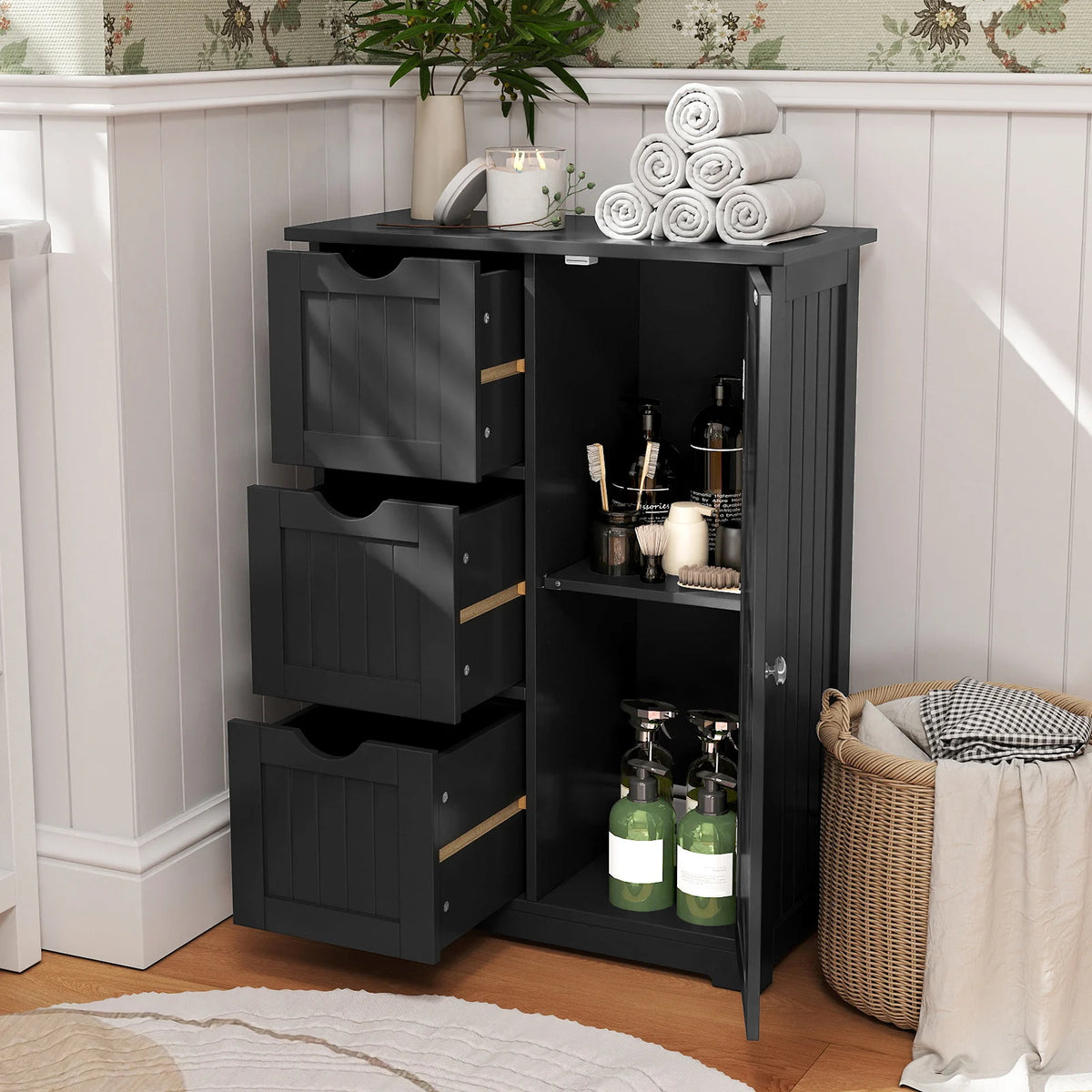 Black bathroom floor cabinet with 3 drawers and a cupboard, towels stacked on top.