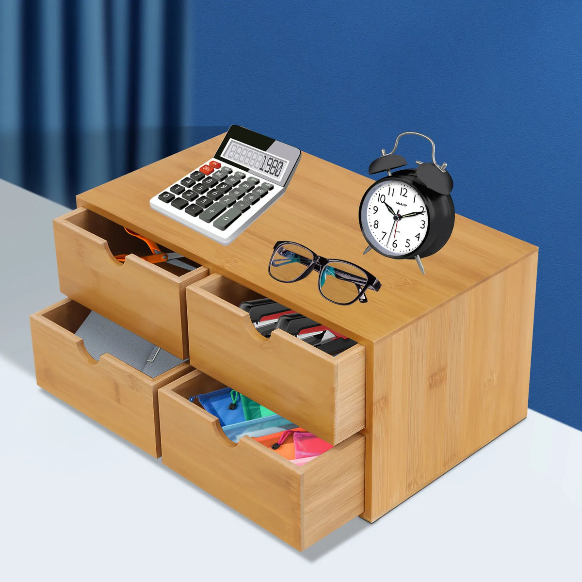Elegant bamboo desktop organizer with 4 drawers by S And B Enterprise; desk setup shows a calculator, glasses, and an alarm clock.