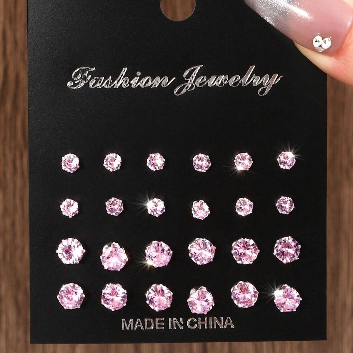 Zirconia stud earrings, pink, 12 pairs on a black display card