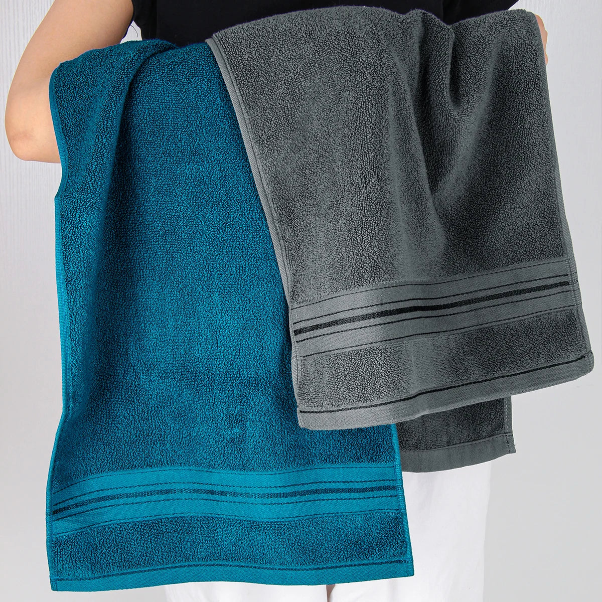 Two pure cotton bath towels in teal and charcoal gray with striped borders