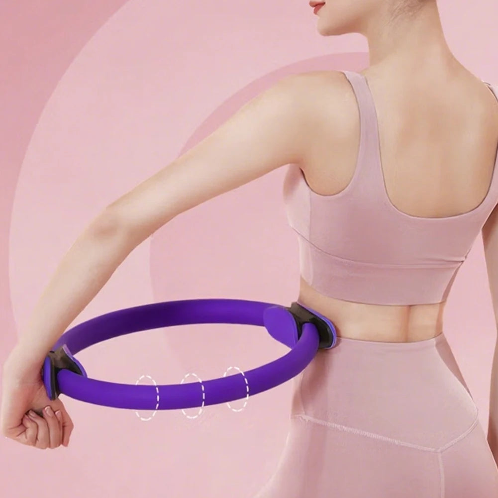 Pilates ring with non-slip handles in purple for core workouts