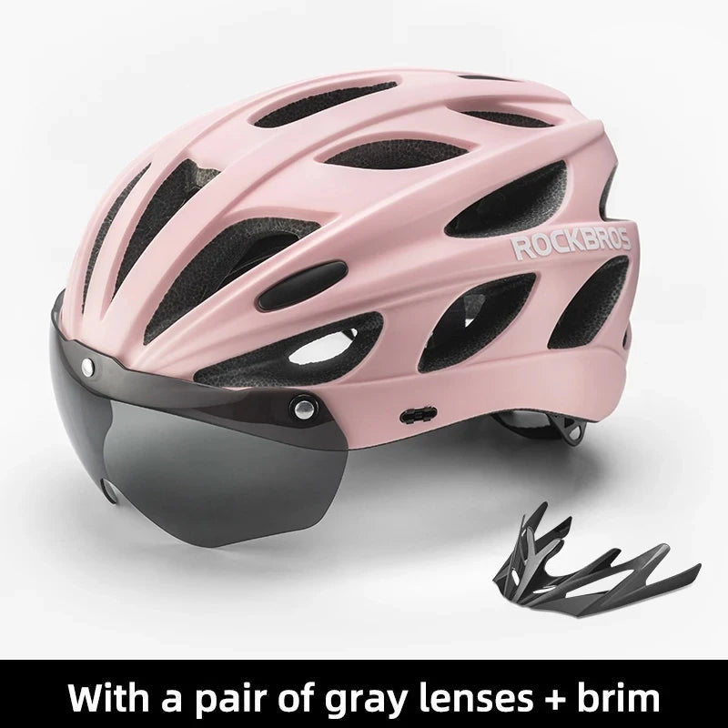 RockBros pink bike helmet with built-in visor, breathable EPS shell, and detachable gray lenses