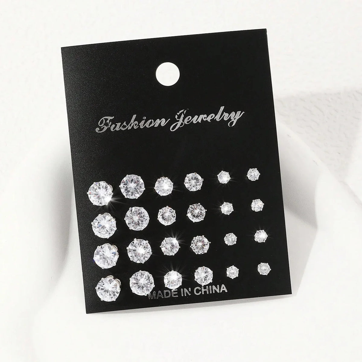 Zirconia stud earrings set, 12 pairs, on a black Fashion Jewelry display card.