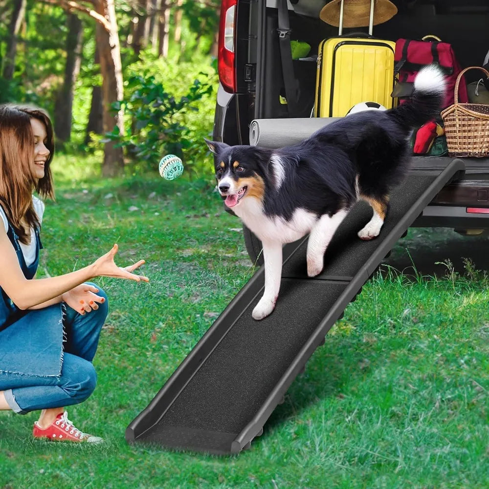 Folding black dog ramp with non-slip surface and raised siderails, shown loading a large dog into an SUV.