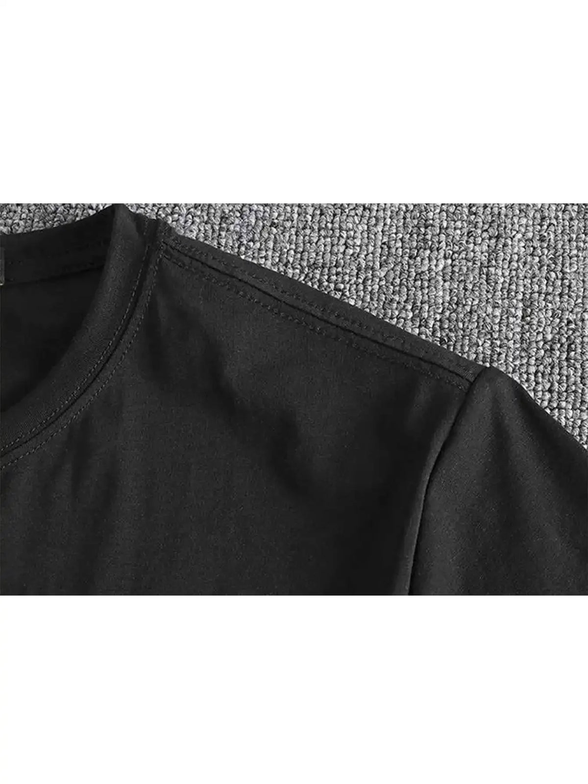 Men's black T-shirt by S And B Enterprise, close-up of neckline seam and fabric.