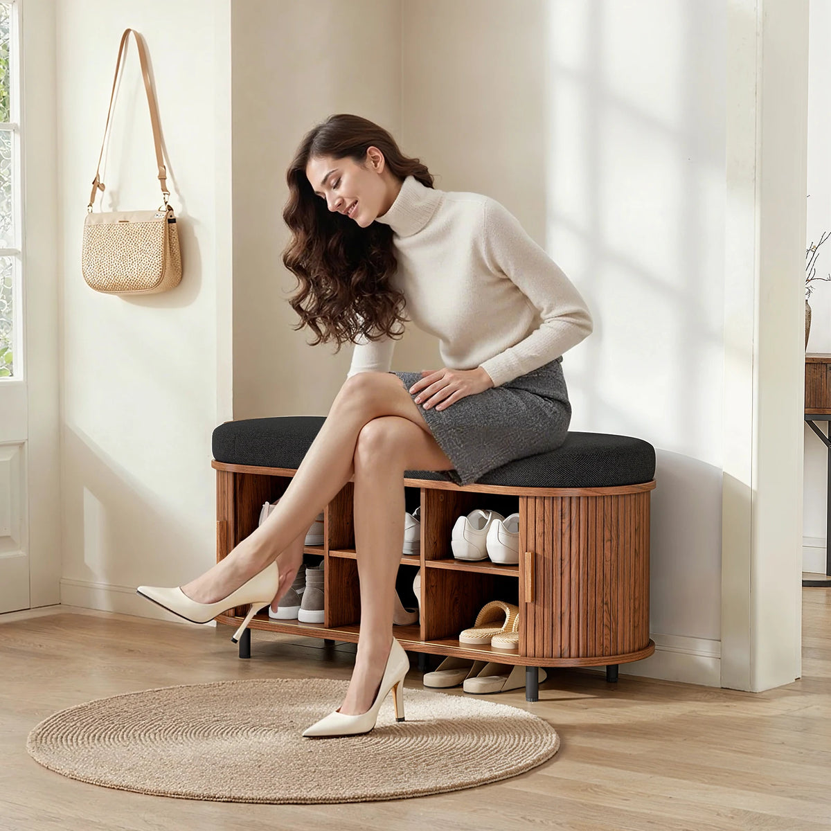 Shoe storage bench with cushioned top, wood finish, and open cubbies for shoes