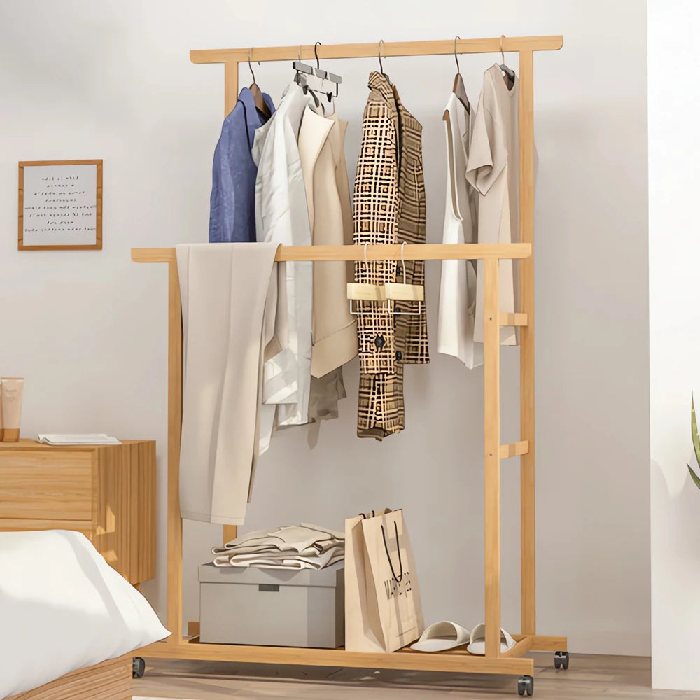 Bamboo clothes rack with double hanging rails on wheels and a lower storage shelf, light wood finish.