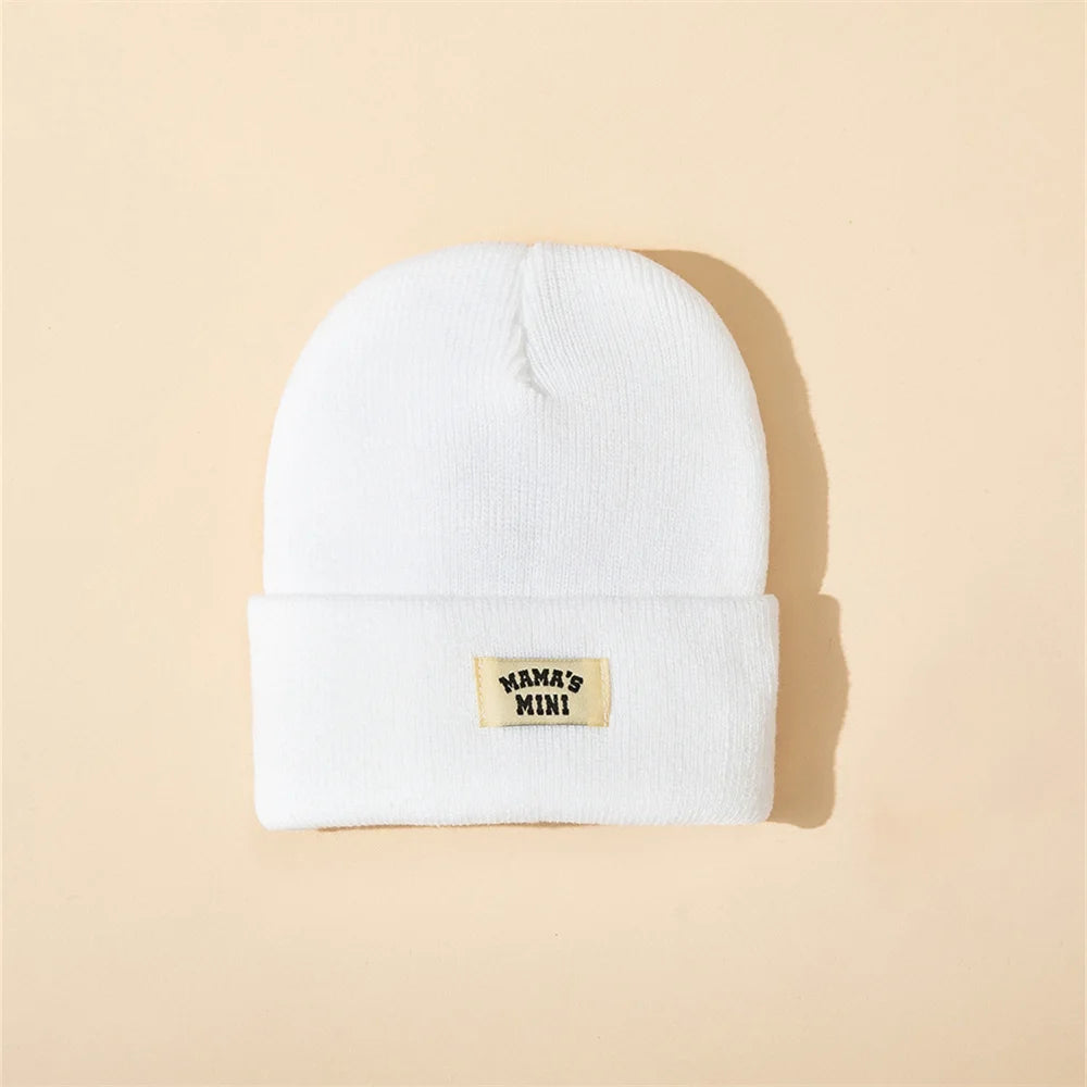 White kids' knitted beanie with folded cuff and Mama's Mini patch