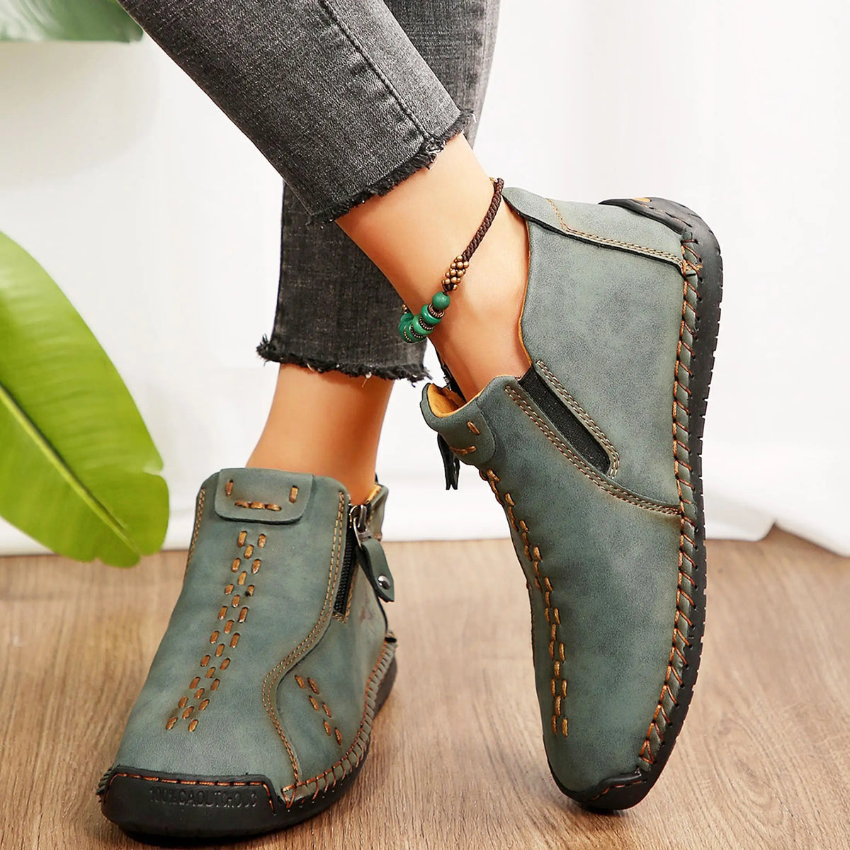 Womens green-gray ankle boots, lightweight slip-on loafers with orange stitching, mid-top pair by S And B Enterprise.