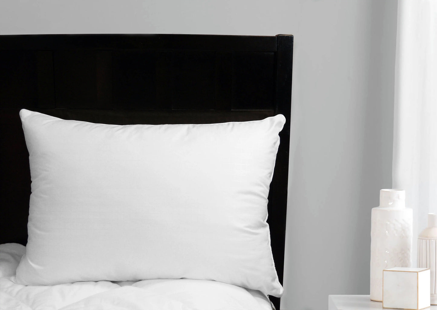 Two white Comfort Complete Bed Pillows, Standard/Queen, on a dark headboard.