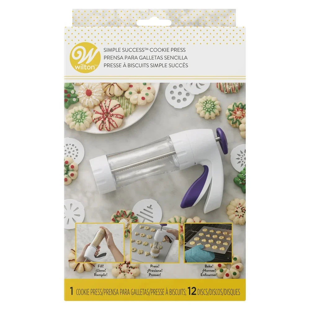 Wilton cookie press with clear barrel and soft-touch purple trigger; includes 12 discs