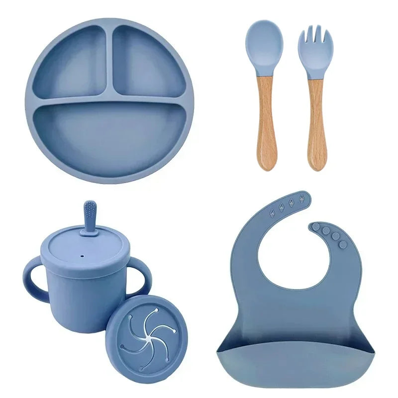 Food Grade Silicone Child Dish Set by S And B Enterprise, blue 5-piece with suction plate, straw cup, spoon, fork, and bib