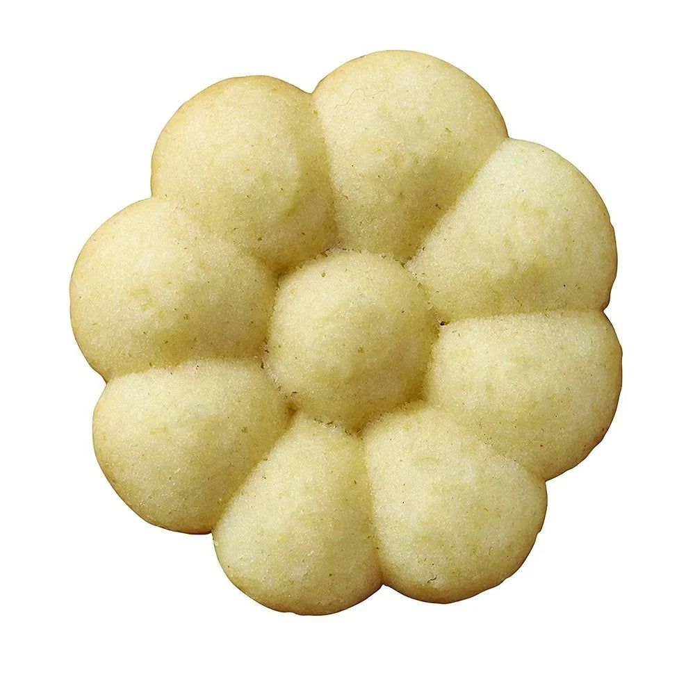 Flower-shaped spritz cookie in pale yellow with a daisy-like petal design.