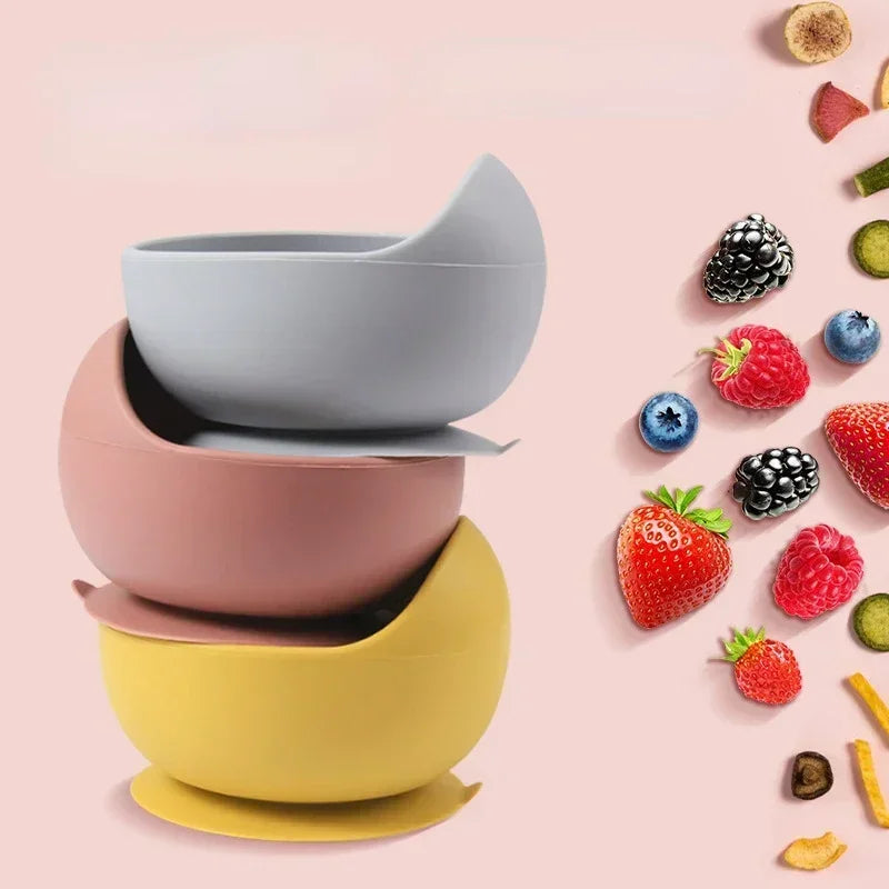 Food-grade silicone child dish set with three suction bowls stacked in blue, pink, and yellow
