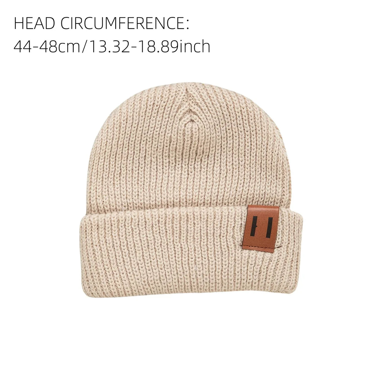 Beige knitted baby beanie hat with folded cuff and brown leather patch.