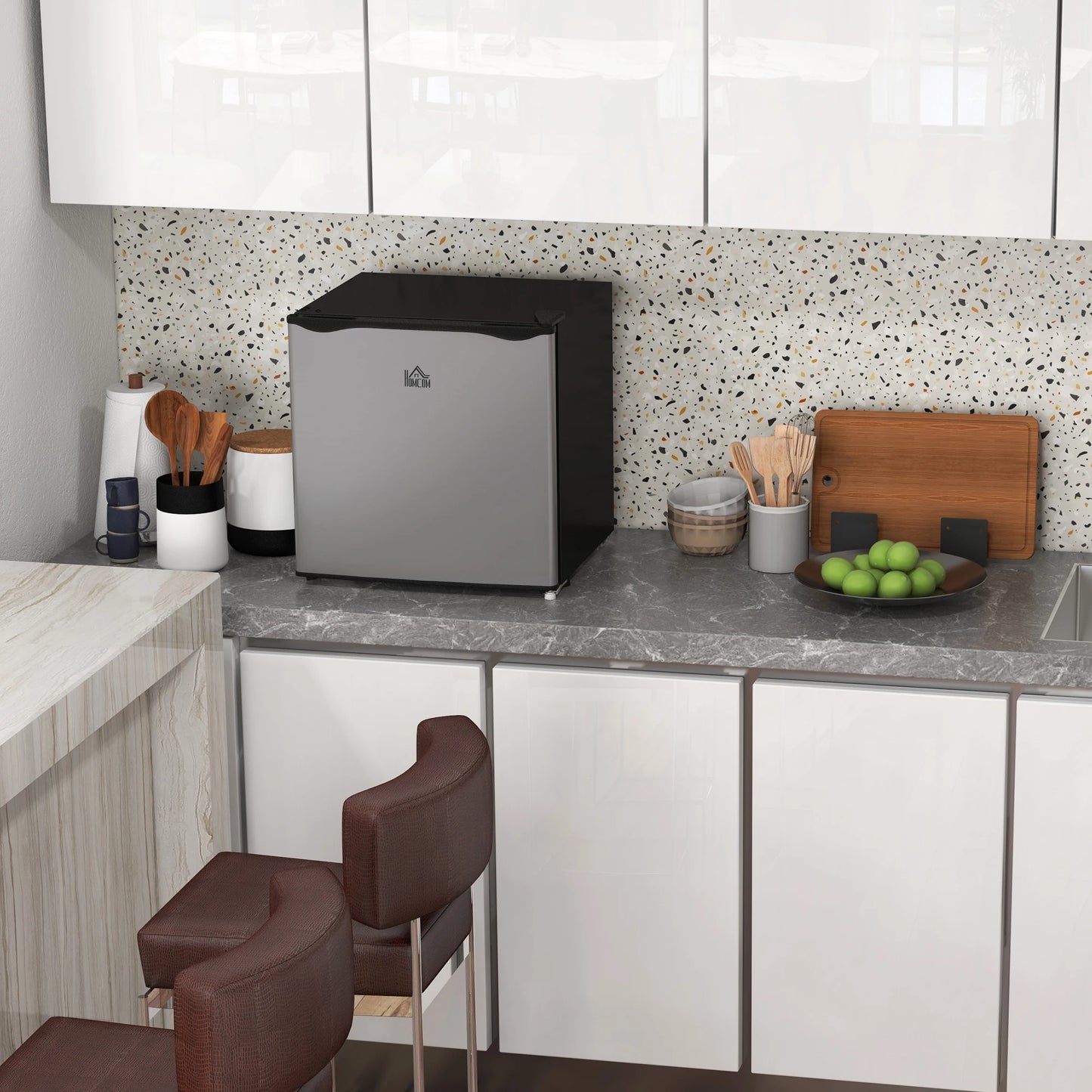 HOMCOM compact upright freezer in silver with a black top in a modern kitchen.