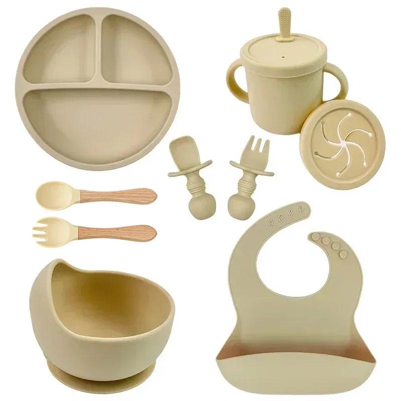 Toddler silicone dish set by S And B Enterprise: suction plate, straw cup, wooden-look spoons and forks, bowl and bib