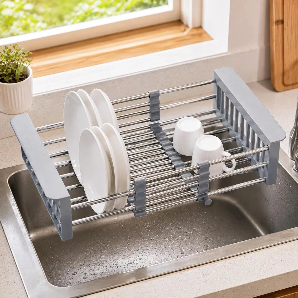 Adjustable stainless steel retractable over-sink dish drying rack by S And B Enterprise; holds plates and cups.