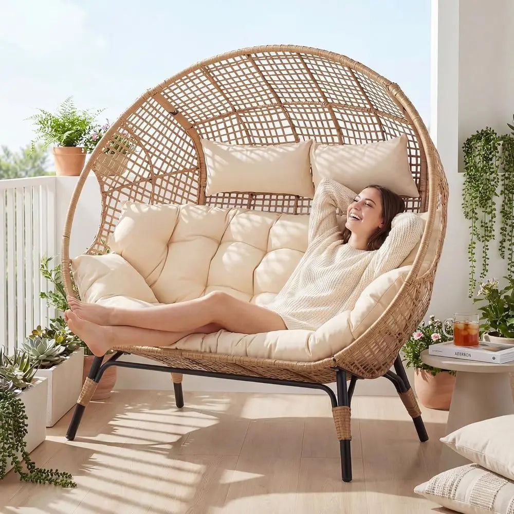 Oversized wicker double egg chair loveseat for 2 with beige cushions, by S And B Enterprise, outdoor patio.