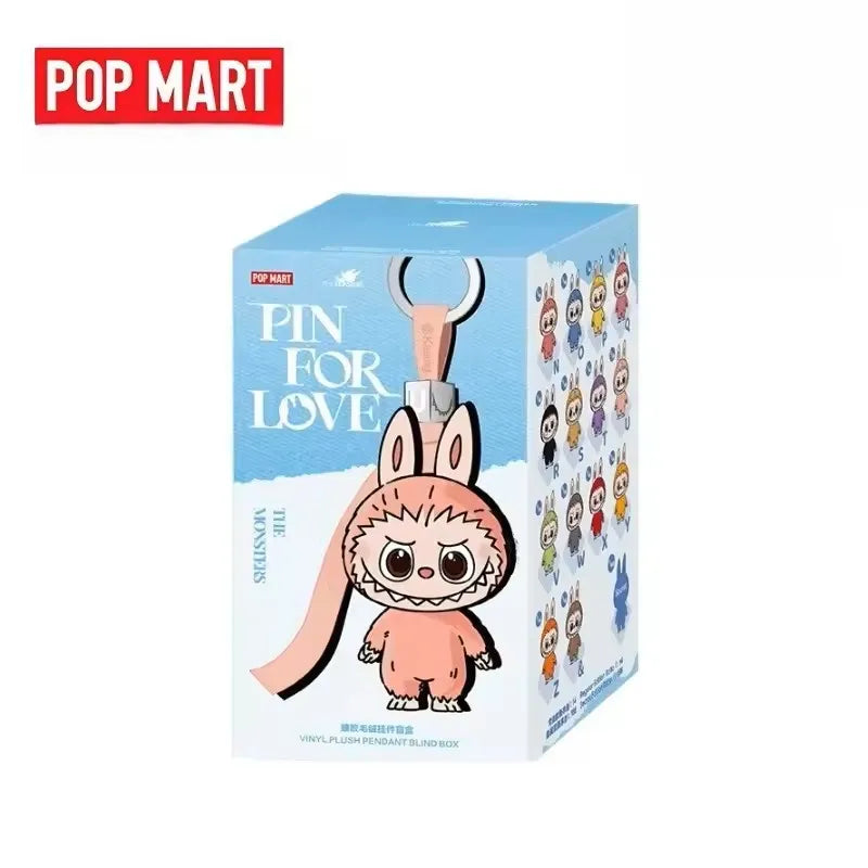 Labubu plush pendant by POP MART; pink bunny-hooded character on blue gift box.
