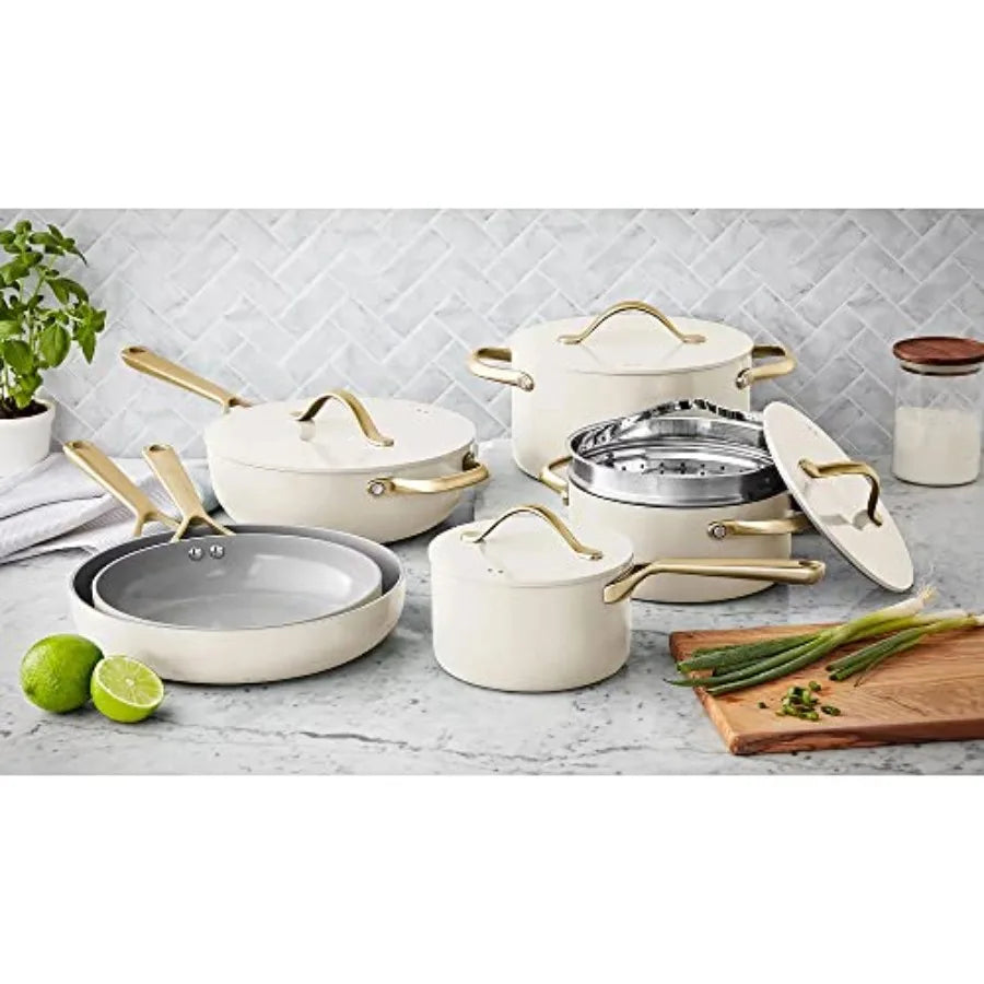 11-piece cream ceramic cookware set with gold-tone handles and lids, includes pots, pans, and steamer insert
