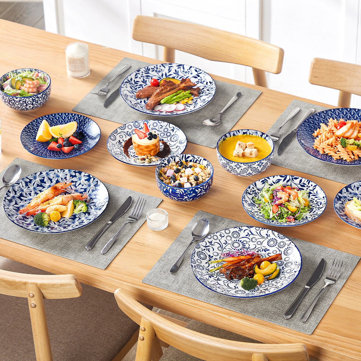 Vancasso blue and white porcelain dinnerware set with floral pattern, plates and bowls on a dining table