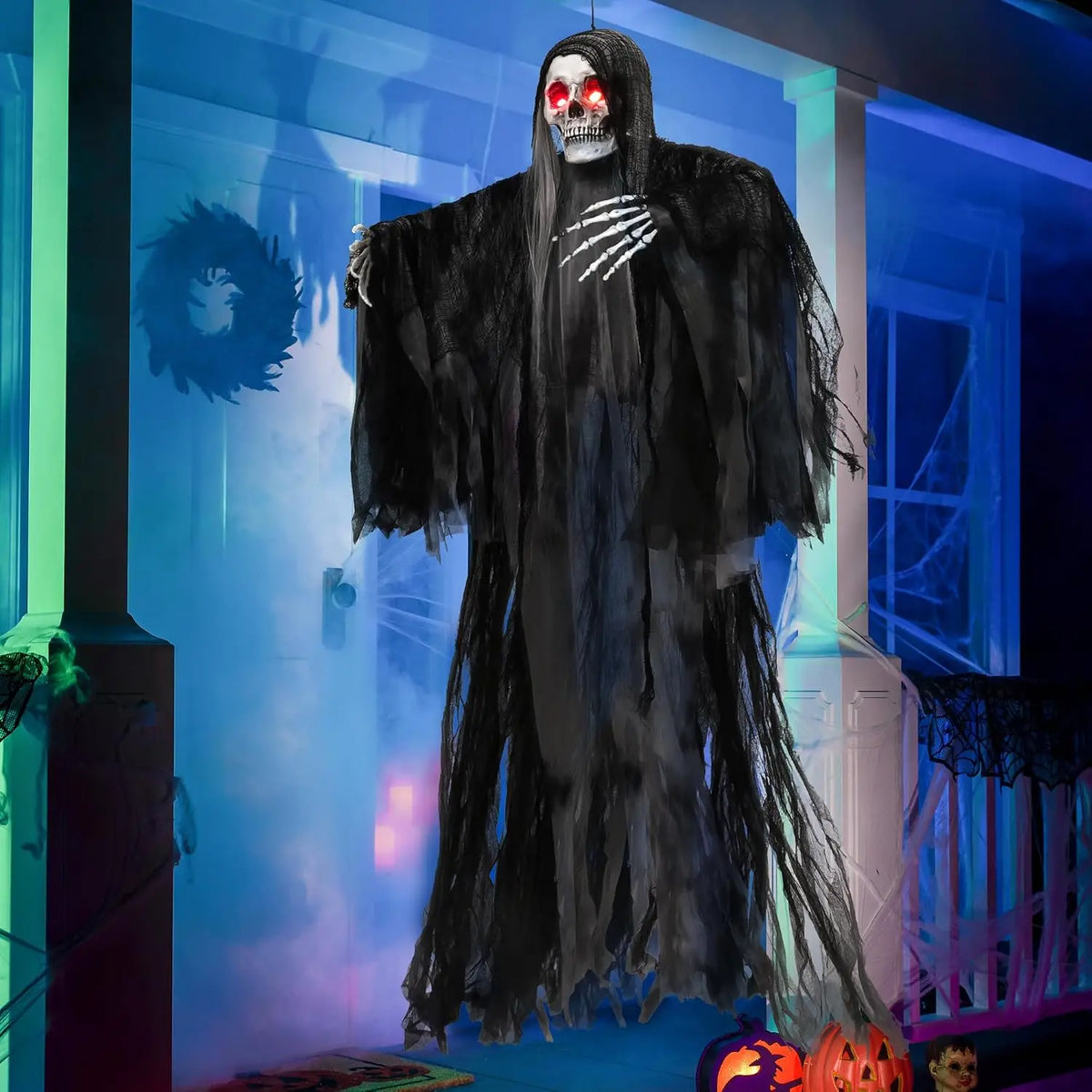 Hanging Grim Reaper Halloween decoration with a tattered black robe and glowing red eyes