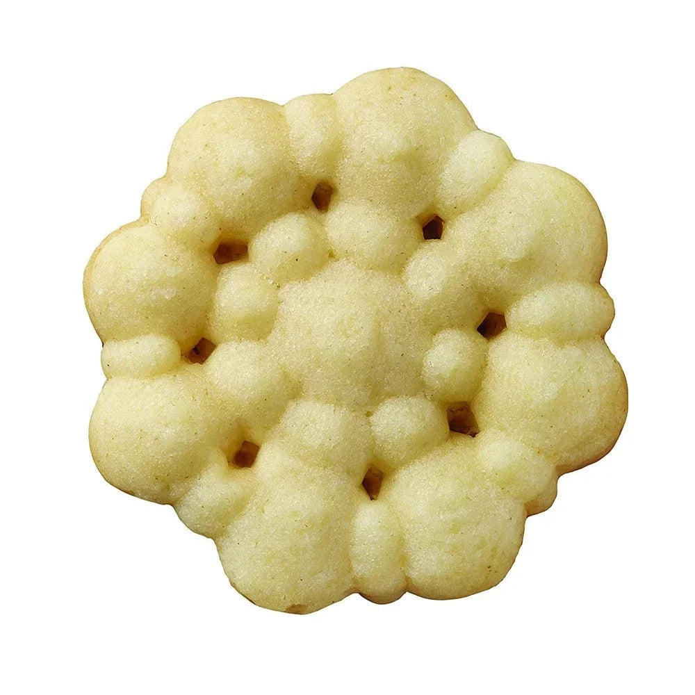 Flower-shaped spritz cookie with pale yellow crumb on white background