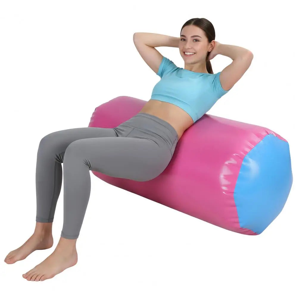 Air roller gymnastics barrel, inflatable pink body with blue ends for home gym, yoga, balance, and cheer training