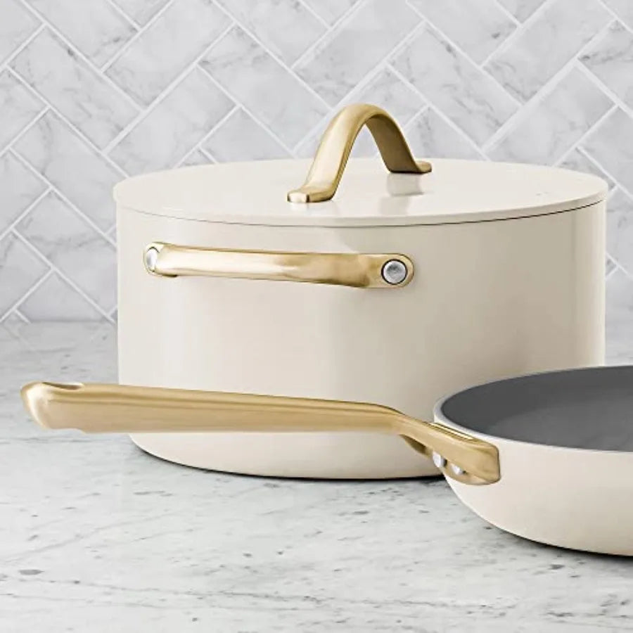 11-piece cream ceramic cookware set by S And B Enterprise with gold handles; pot with lid and frying pan shown.