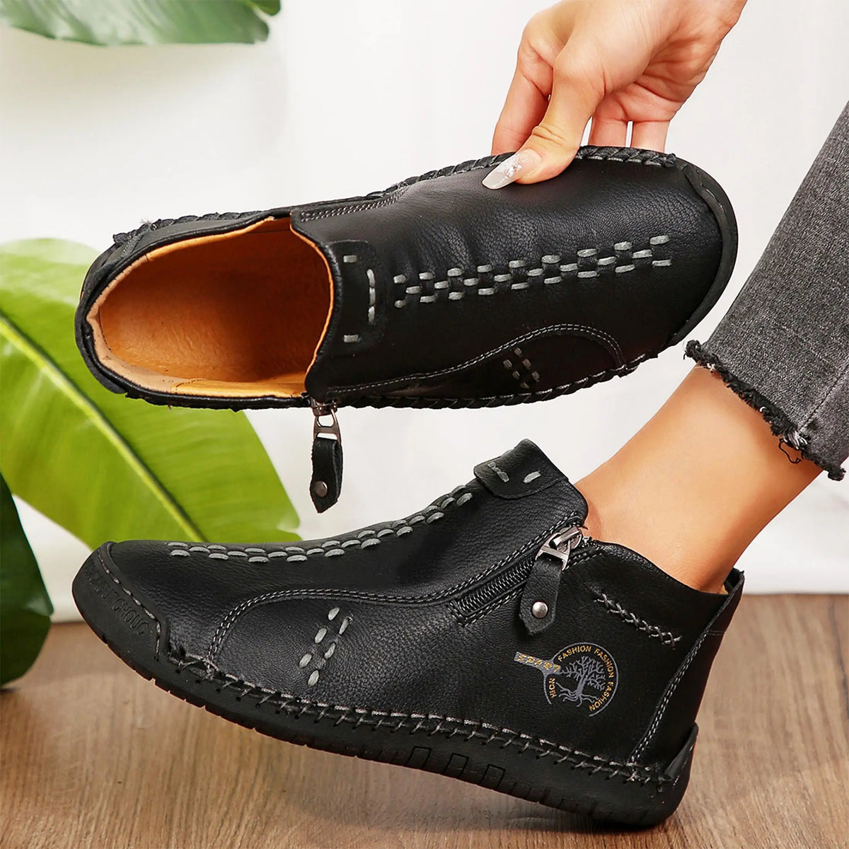Women's black leather slip-on loafers with decorative white stitching, mid-top casual driving shoes